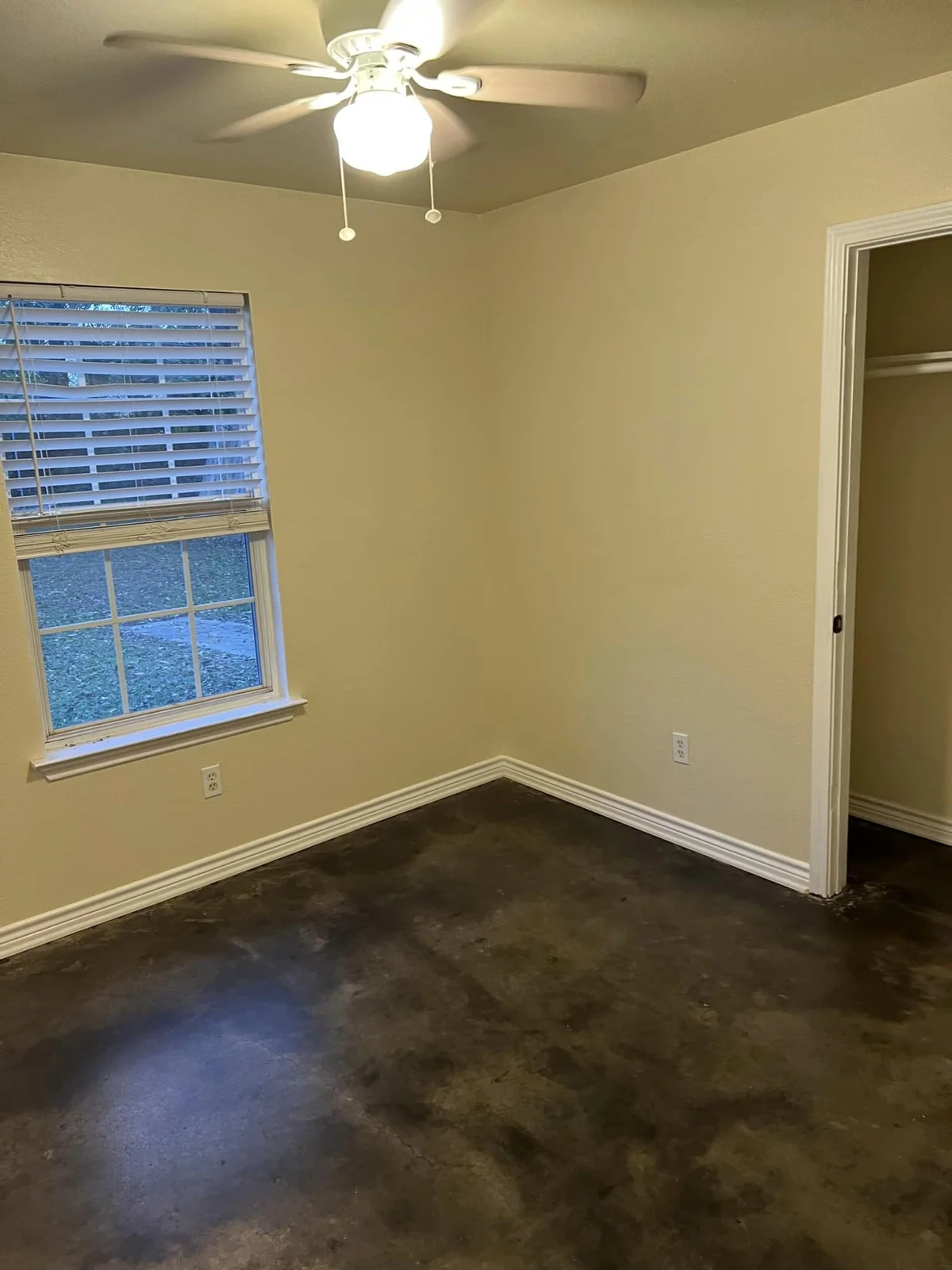 A room with neutral walls and a window at Eagle Inn Apartments